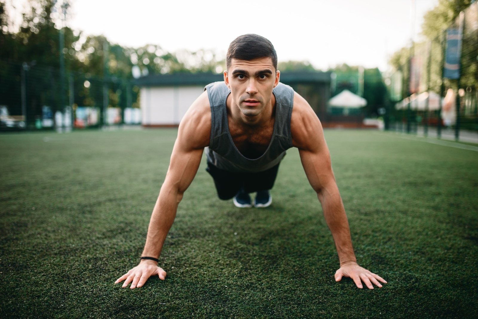Athlete doing push-up exercise on outdoor workout