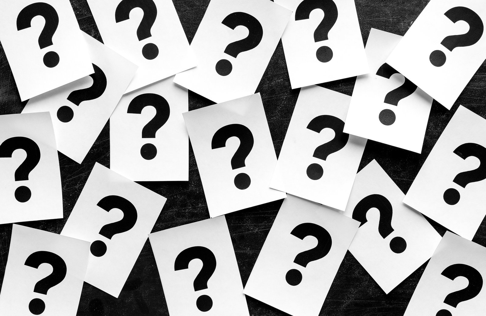 Bold black question marks on paper cards